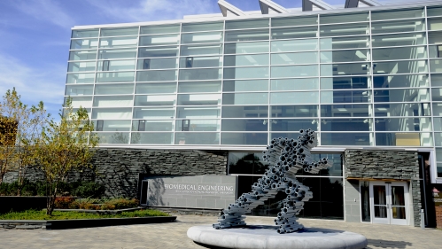 running man sculpture made of pipes in front of biomedical engineering building 