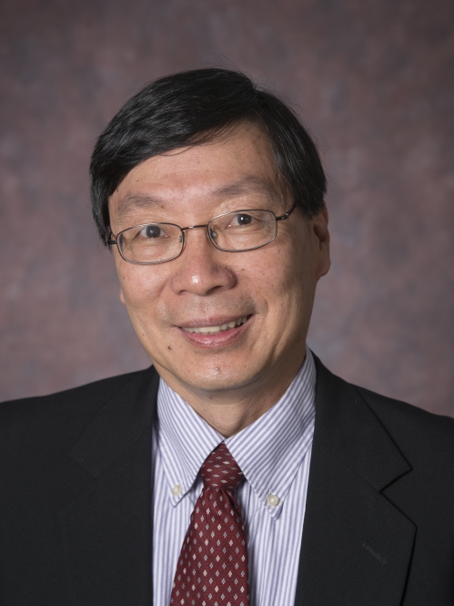 head shot of an Asian male with short black hair with eyeglasses wearing a black suit, light blue and white striped shirt, and a maroon tie