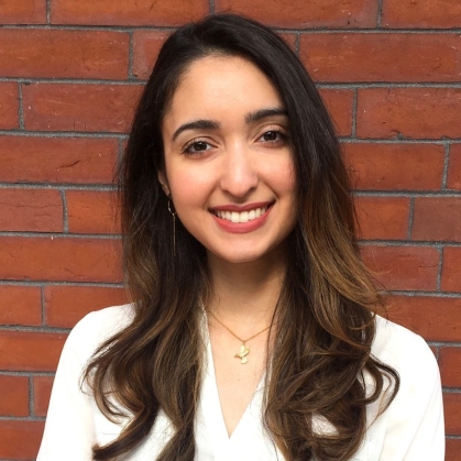 head shot of young woman with long dark brown hair wearing a white blouse