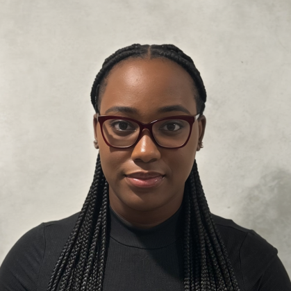 Head shot of a female college student. She is wearing glasses and her hair is braided.