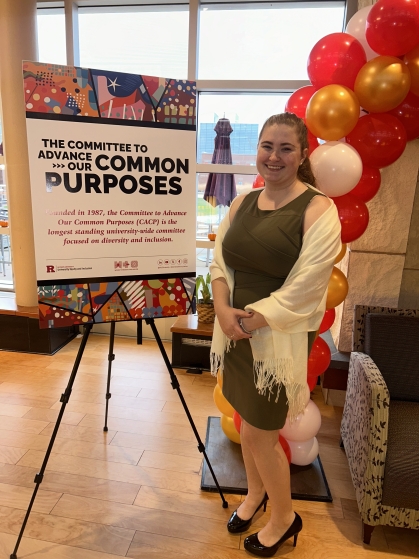 Young woman standing with her research poster.